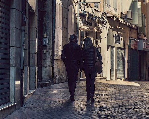 middle aged couple walking and holding hands